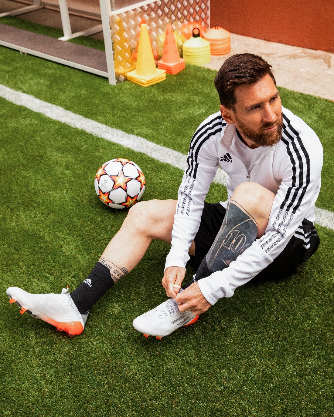 A person kneeling on the grass with a football ball

Description automatically generated with low confidence