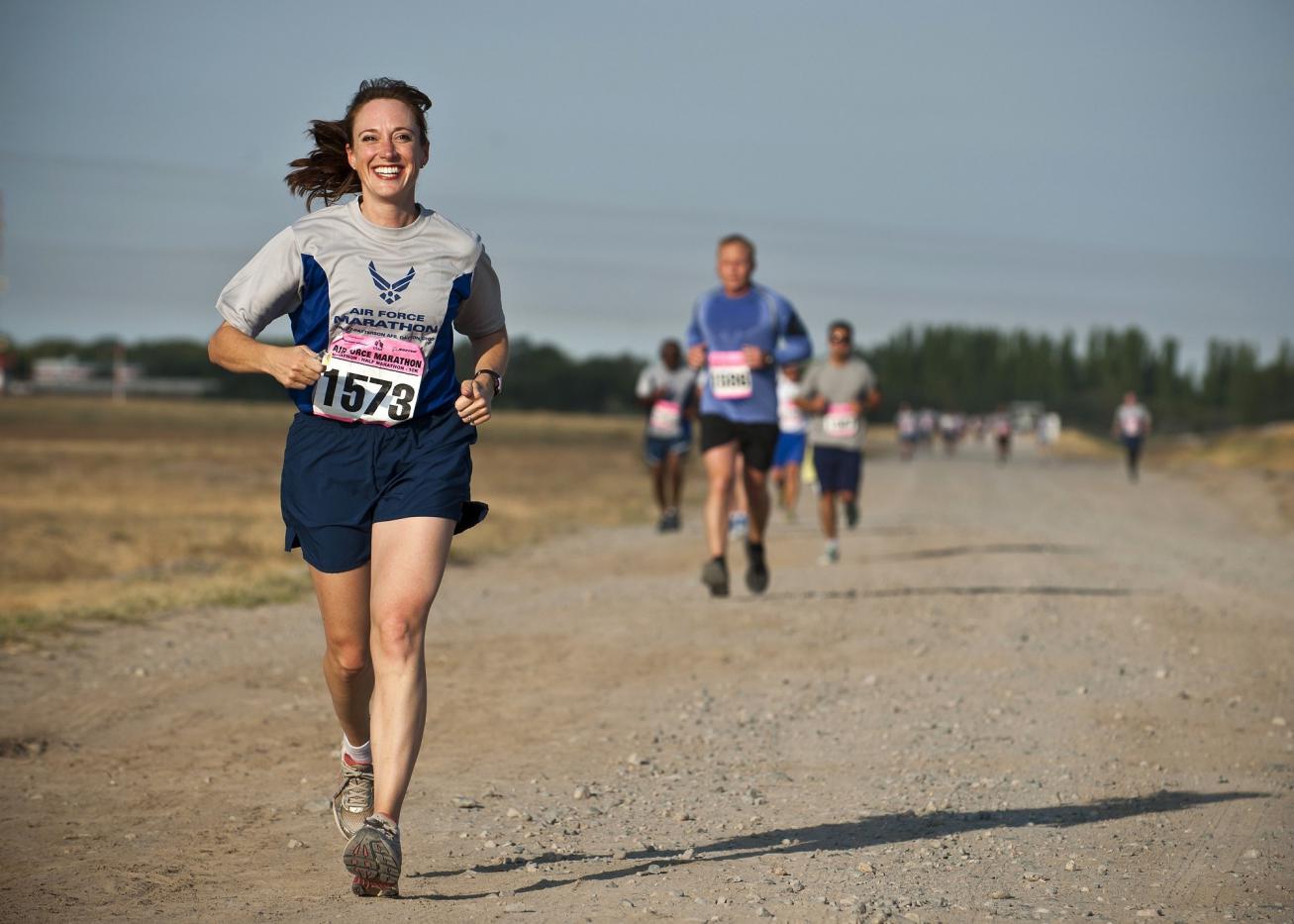 woman-in-gray-crew-neck-shirt-running-on-brown-soil-during-34495