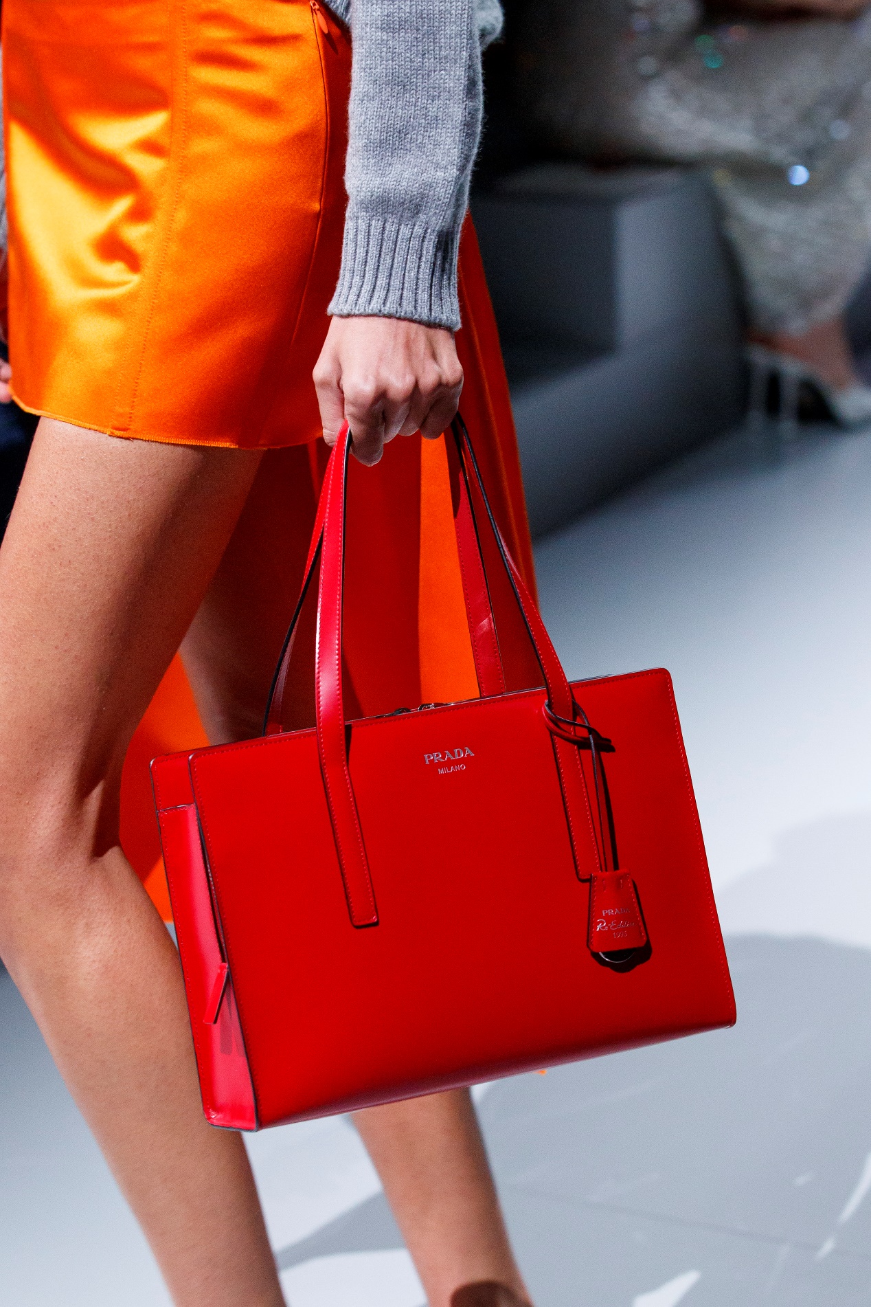 A person holding a red bag

Description automatically generated with low confidence
